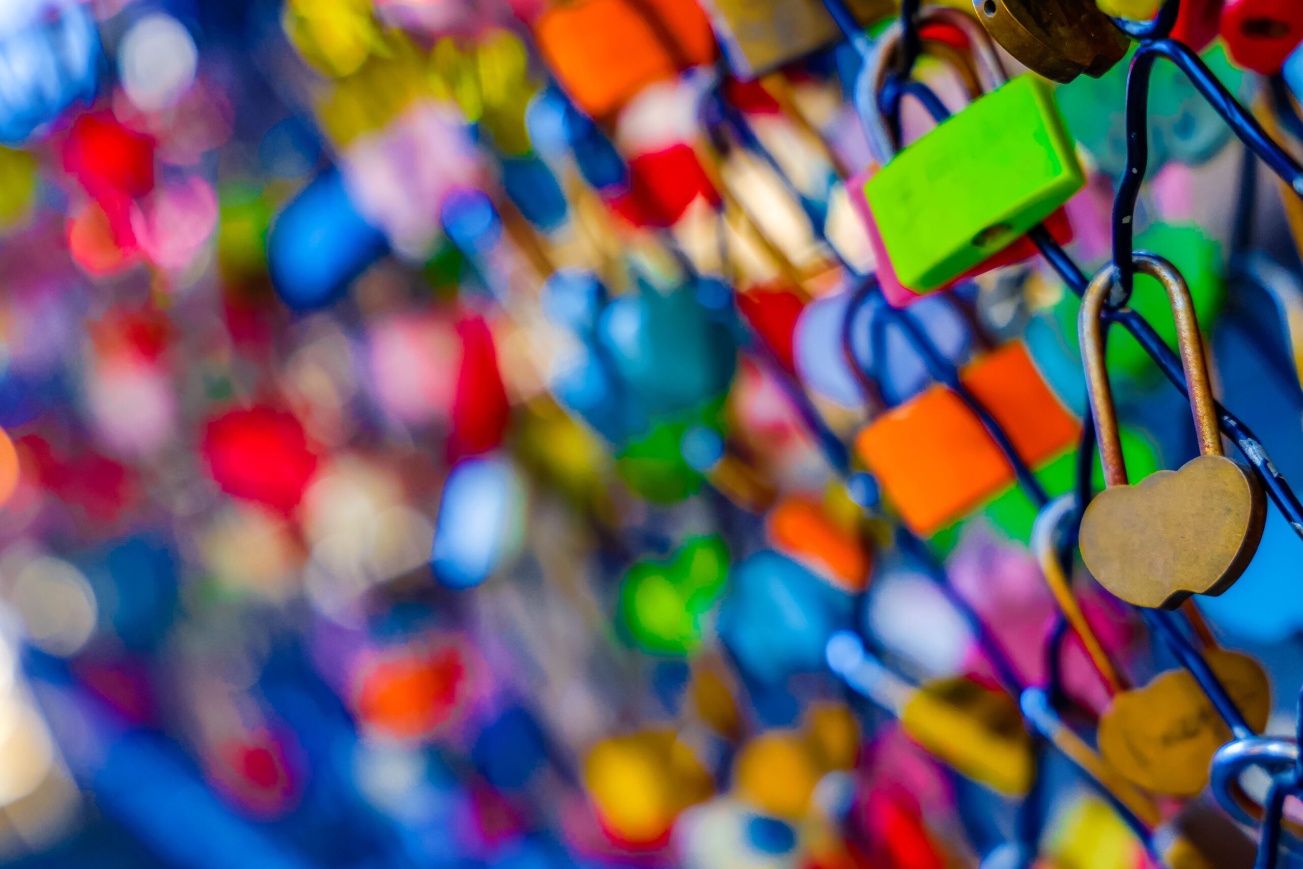 A closeup of colorful love locks on the fence in Longqing Gorge, Beijing.